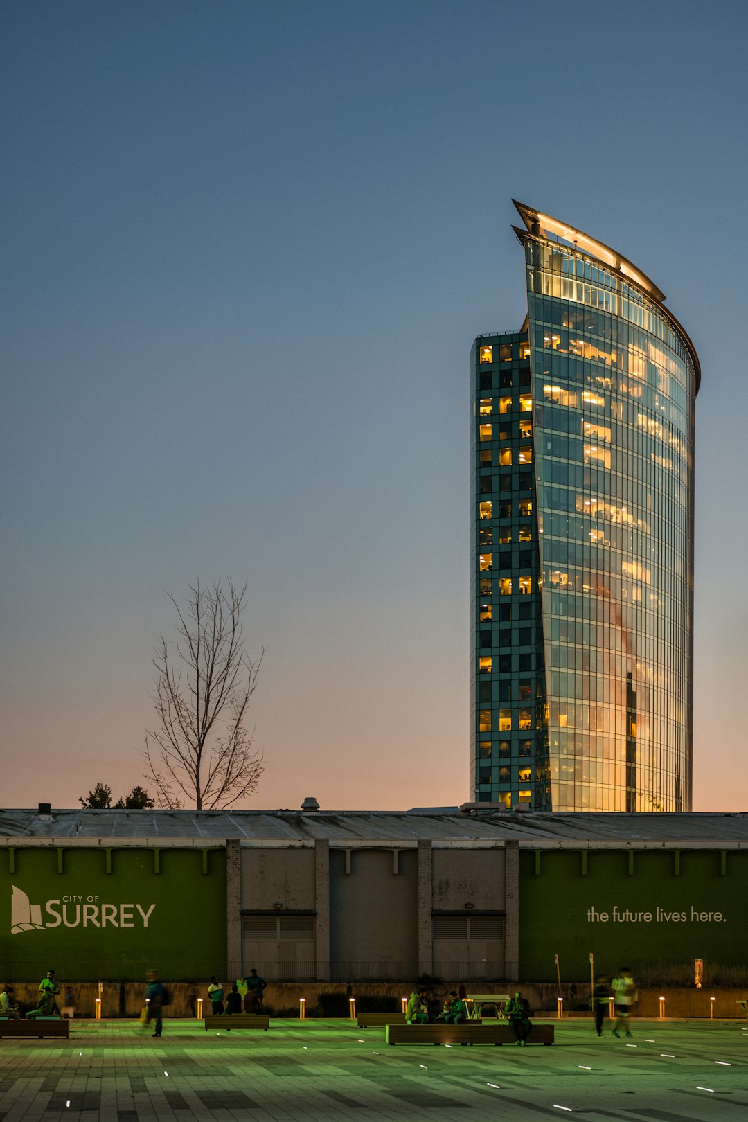 a very tall building sitting next to a parking lot Surrey Local