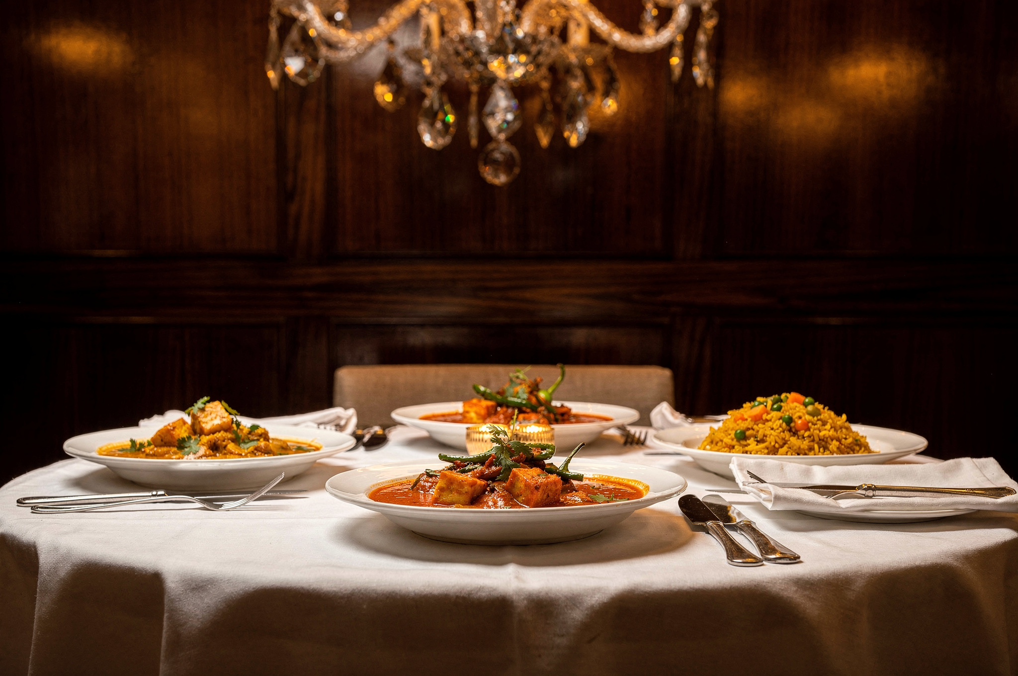 indian restaurant dining table with curry dishes