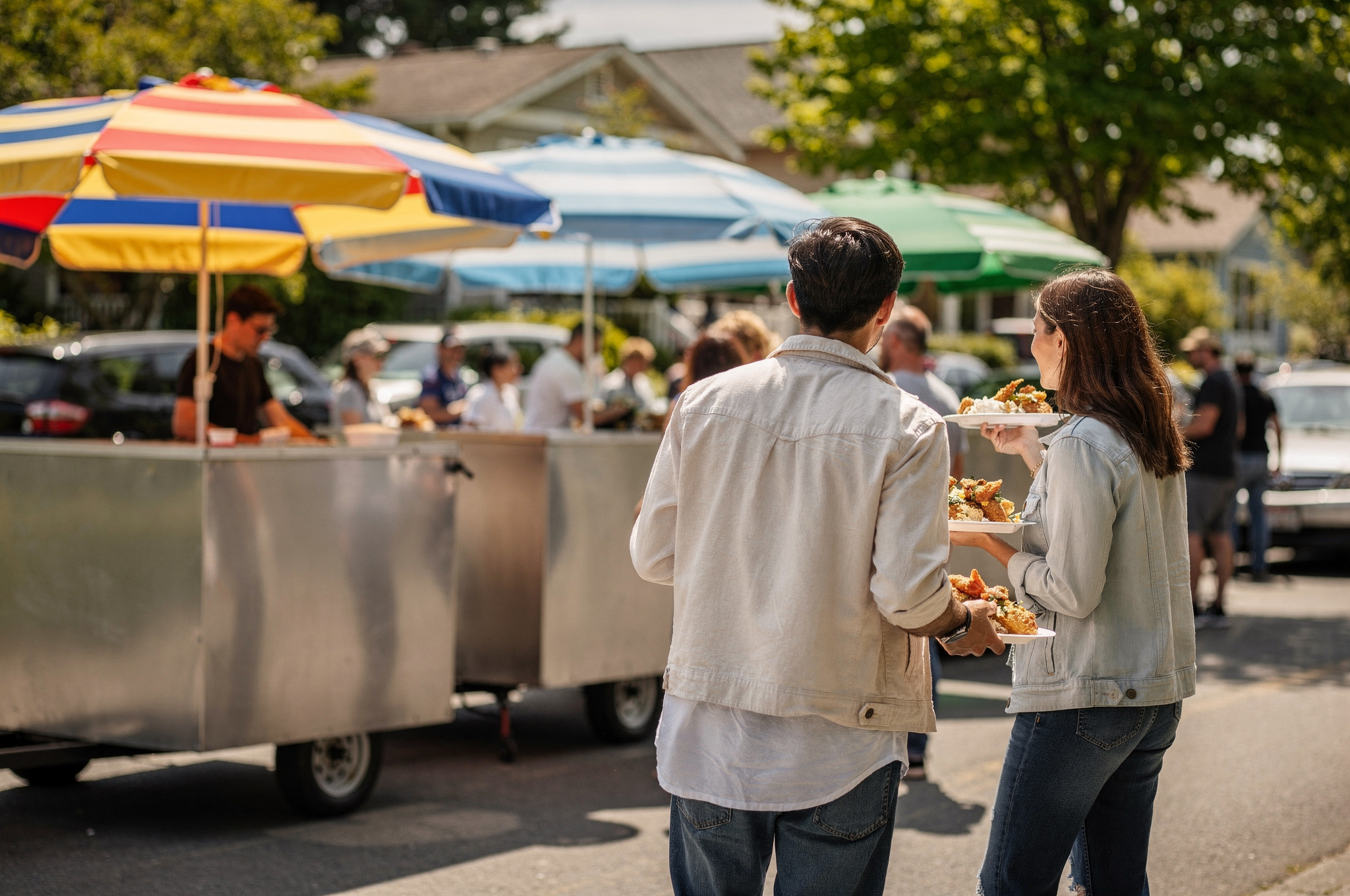 culinary heritage in newton v2 Newton Surrey: Neighbourhood Food Tour people carrying plates of food at an outdoor food cart gathering in Newton