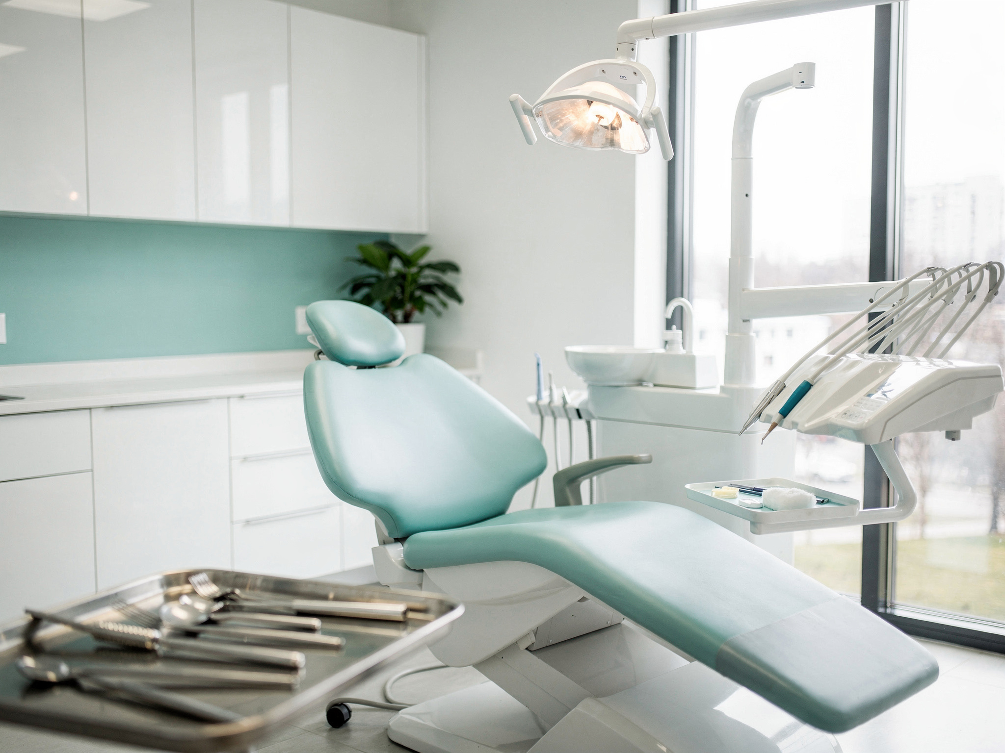 Modern dental treatment room with teal accents